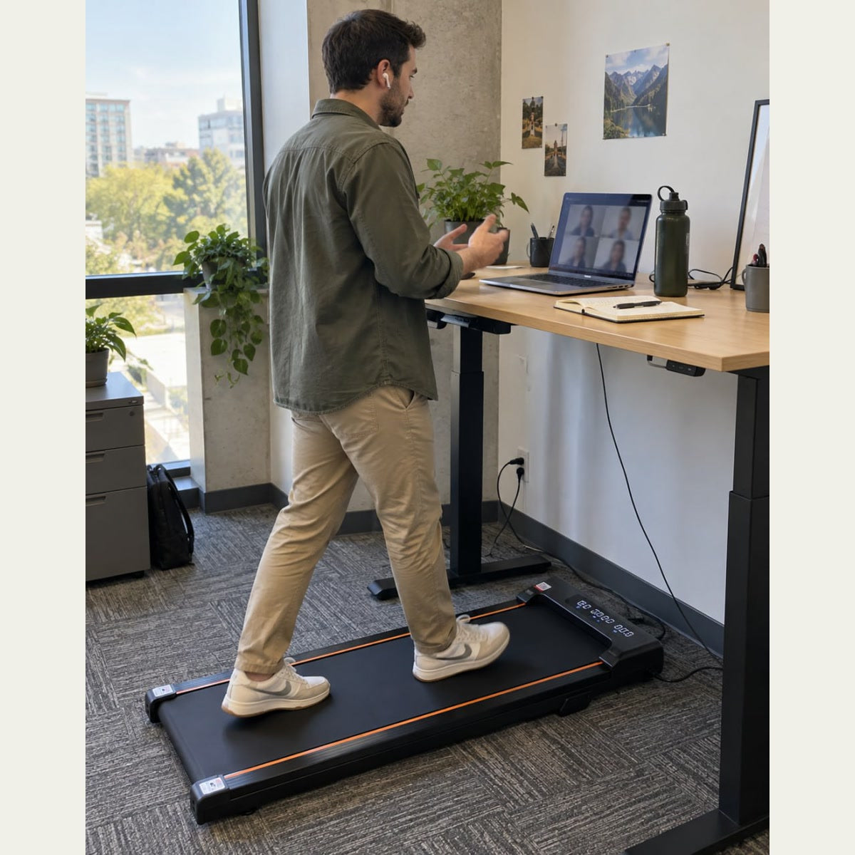 Man walking on StepFlow beside a standing desk during an office call